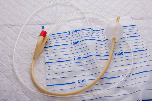 nurse inflates urinary catheter bulb with leg drainage bag on sterile field
